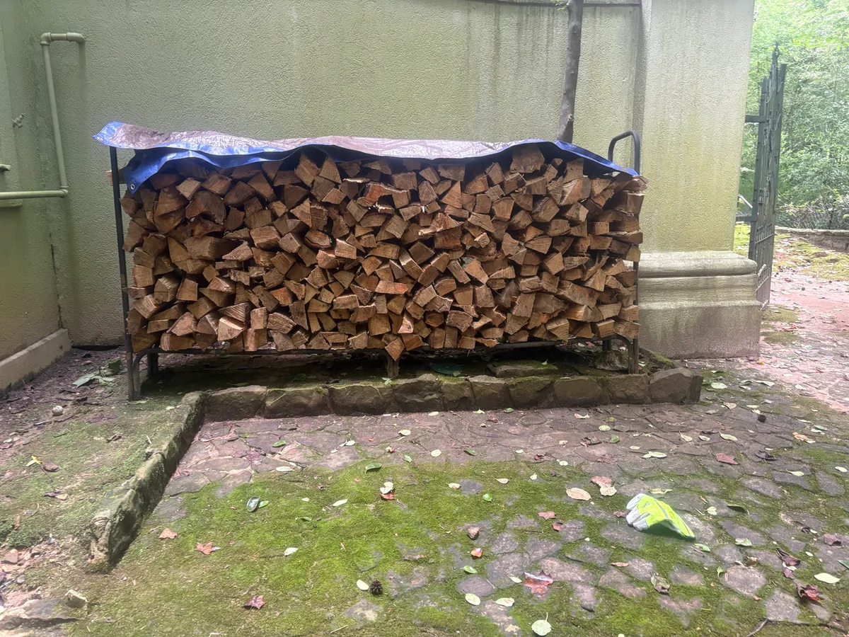 Previous Moss and Sons delivery stacked in a metal rack beneath a blue tarp
