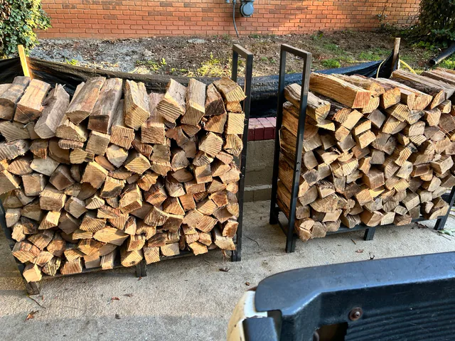Split firewood neatly stacked in two metal racks